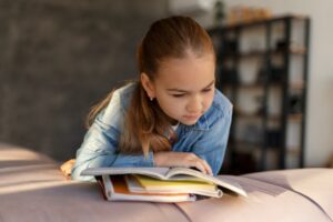 young-girl-reading-sofa_23-2149173384